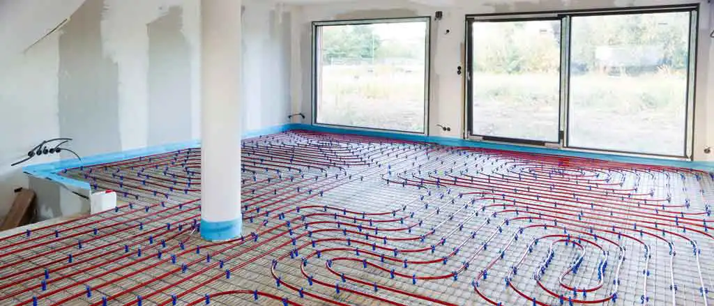 Système de plancher chauffant en cours d'installation dans une grande pièce lumineuse